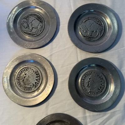 Set of seven vintage pewter coin-motif coasters featuring designs of Mercury dimes, Buffalo nickels, Indian Head pennies, and a Strawbery...