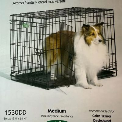 Product packaging photo for a medium-sized black wire dog crate featuring dual front and side doors with a removable bottom tray.