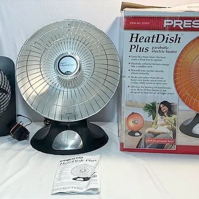 Presto HeatDish Plus parabolic electric heater with its original retail box and manual, displayed alongside a small black portable...