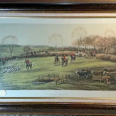 Framed equestrian art print depicting a traditional English fox hunt, housed in an ornate mottled brown and gold frame with a cloth mat.