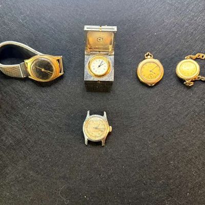 Collection of vintage gold-tone and silver-tone watches, including wristwatches with curb chain bands, a pocket watch, and a miniature...