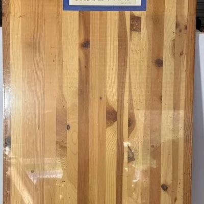 Laminated pine shelving board sealed in original plastic wrap, measuring 21/32" x 23-1/4" x 48".