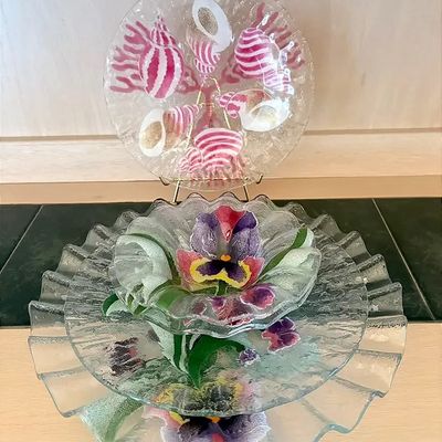 Collection of decorative textured clear glass plates with hand-painted seashell and pansy floral designs.