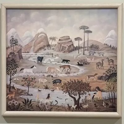 Framed folk art style painting depicting a biblical landscape scene with various animals and figures, presented in a light wood frame.