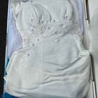Preserved white wedding dress with floral embroidery and beaded detailing, stored in a original preservation box.