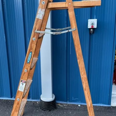 Vintage Werner wooden A-frame stepladder with fold-out paint shelf and original safety labels.
