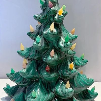 Vintage ceramic Christmas tree with a green glaze finish and colorful plastic light pegs, circa 1970s.