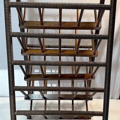Vintage dark-stained wooden quilt rack with spool-turned detailing and multiple display tiers.