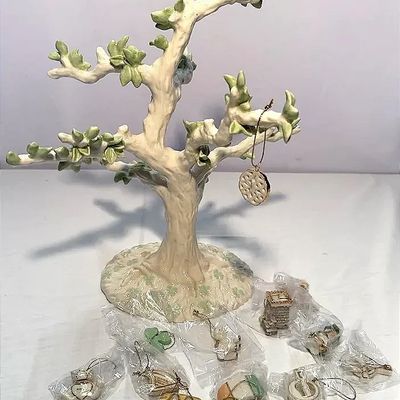 Irish porcelain tree display stand featuring soft green leafy branches and a clover-patterned base, accompanied by a collection of small...