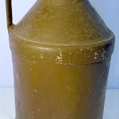 Vintage olive green molded plastic jug with a side handle and flared neck, showing minor age-related scuffs.