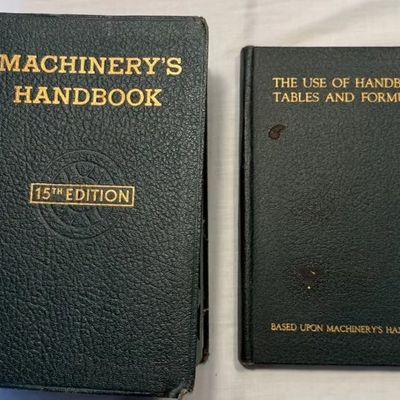 Machinery's Handbook 15th Edition alongside its companion volume, The Use of Handbook Tables and Formulas, both in dark green...