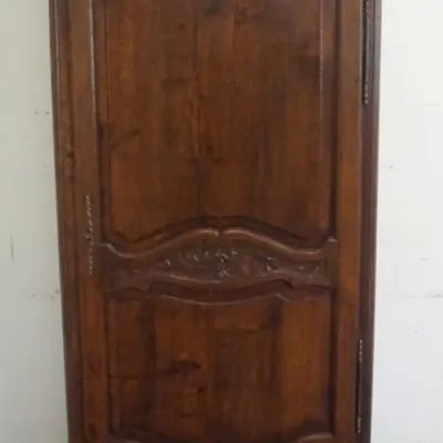 Sale Photo Thumbnail #193: 1192	CONTINENTAL CARVED OAK NARROW ONE DOOR CABINET W/LOWER DRAWER, FLORAL CARVING AT CREST & CENTER OF DOOR, PANELED SIDES W/4 INTERIOR ADJUSTABLE SHELVES, APPROXIMATELY 35 IN X 18 IN X 78 IN HIGH																																																										
