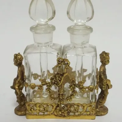Sale Photo Thumbnail #3: 1003	GLASS PERFUME BOTTLES W/DABBERS IN ORNATE GILT METAL HOLDERS W/CHERUBS, APPROXIMATELY 4 IN X 1 1/2 IN X 5  IN HIGH																																																																																																																																								