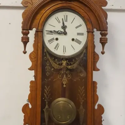 Sale Photo Thumbnail #140: 1140	WALNUT WALL CLOCK W/ARCHED TOP HAVING TURNED DROP FINIALS, APPROXIMATELY 14 IN X 6 IN X 36 IN HIGH																																																																																																																																																								