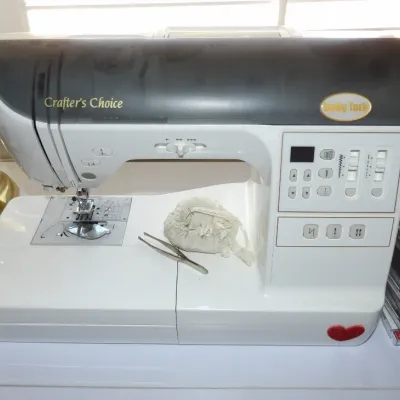 Baby Lock Crafter's Choice sewing machine featuring a digital display, control buttons, and various stitch selections, presented...