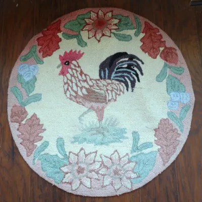 Vintage handmade round hooked rug featuring a central rooster motif surrounded by a floral border in soft pastel and earth tones.