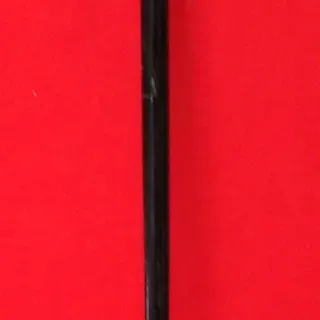 Vintage black wooden walking cane featuring an ornate  knob handle with intricate embossed detailing.
