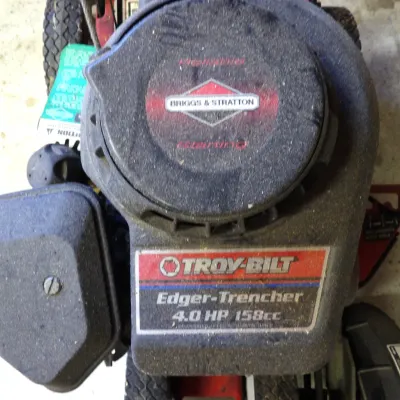 Troy-Bilt Edger-Trencher equipped with a Briggs & Stratton 4.0 HP 158cc engine, showing typical dust and wear from outdoor use.