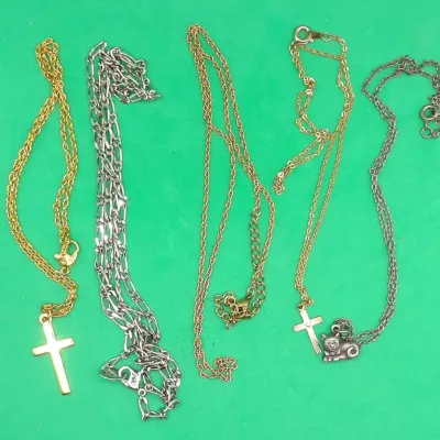 Collection of five assorted chain necklaces, including gold-tone and silver-tone styles featuring a plain cross pendant, a textured cross...