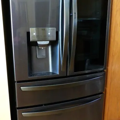 LG ThinQ modern french door refrigerator in a dark stainless steel finish, featuring an InstaView door-in-door glass panel and exterior...