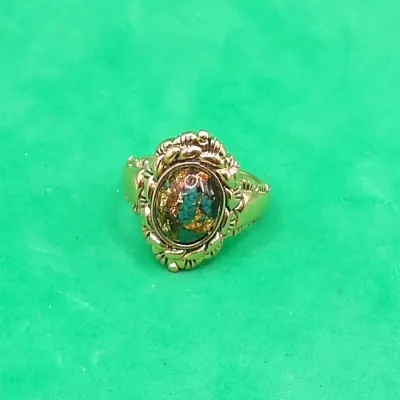 Vintage gold-tone statement ring featuring an oval faux turquoise and gold flake cabochon set in an ornate rope-detail bezel.