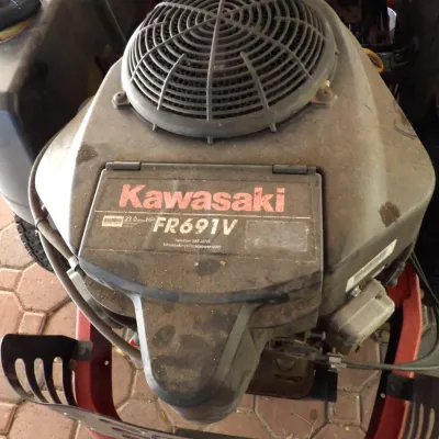 Kawasaki FR691V 23.0 horsepower V-twin lawn mower engine mounted on a riding tractor frame, showing light surface dust from use.