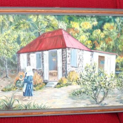 Framed original landscape painting depicting a red-roofed cottage and figure, signed Danet in the lower right corner.
