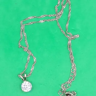 Silver-tone necklace featuring a round brilliant-cut clear crystal solitaire pendant on a delicate twisted rope chain with an adjustable...