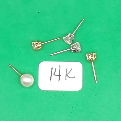 Selection of 14K gold stud earrings, including single cubic zirconia and pearl posts in white and yellow gold.