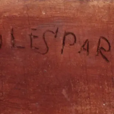 Hand-carved signature reading 'JULES PARISIEN' incised on the wooden surface of a piece.
