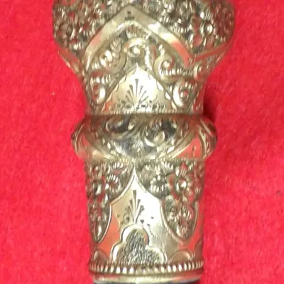 Walking cane featuring an ornately gold-filled or brass chased knob handle with elaborate floral and repoussé scrollwork mounted on a...