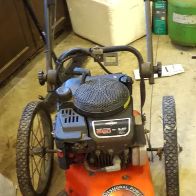 DR Power Equipment walk-behind trimmer mower equipped with a Briggs & Stratton 6.50 Easy Start engine, large spoked rear wheels, and...