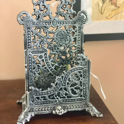 Ornate cast iron letter holder or desktop organizer featuring intricate filigree and floral patterns with a silver-black distressed finish.