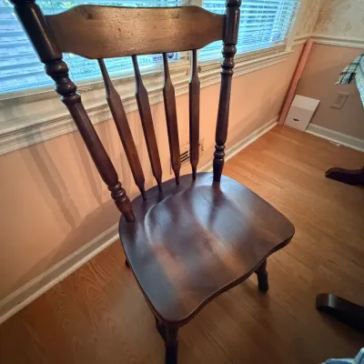 Sale Photo Thumbnail #242: Traditional dark wood spindle-back dining chair featuring turned stiles and a contoured solid wood seat.