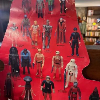 Vintage Kenner Star Wars action figure cardback insert showing various characters, featuring creasing, edge wear, and small handwritten...