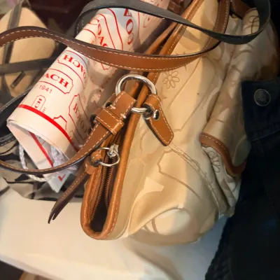 Sale Photo Thumbnail #243: Coach beige canvas monogram tote bag with tan leather trim, along with a branded Coach dust bag or box lining paper.