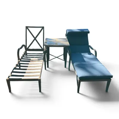 Two Metal Outdoor Chaise Lounge Chairs With Table