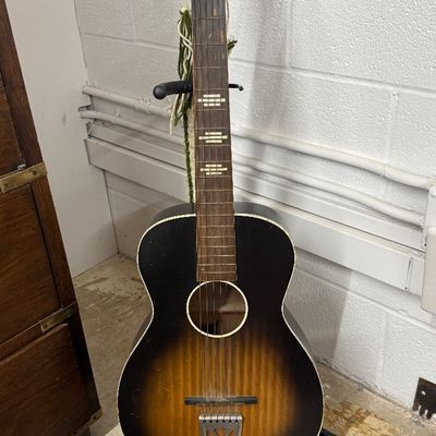 Vintage Stella acoustic parlor guitar in a sunburst finish, showing light surface wear and age-consistent patina.