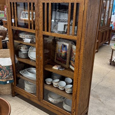 Sale Photo Thumbnail #11: Mission Arts and Crafts style oak display cabinet filled with fine china and decor items.