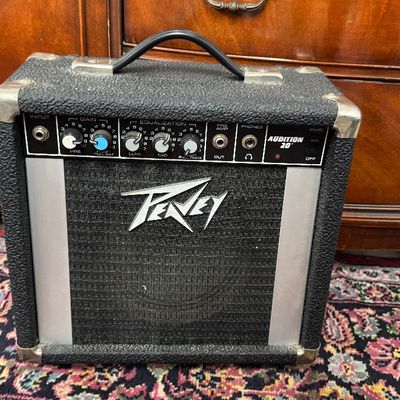 Vintage Peavey Audition 20 guitar amplifier featuring a black textured casing, corner protectors, and top control panel.