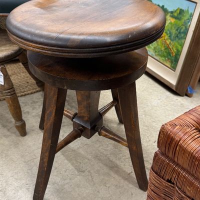 Sale Photo Thumbnail #3: Vintage dark stained wood swivel piano stool with round seat and turned cross-spoke stretchers.