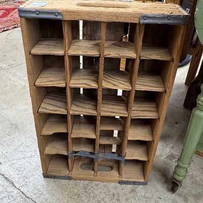 Vintage wooden soda crate standing upright, featuring 24 compartments and metal corner brackets.