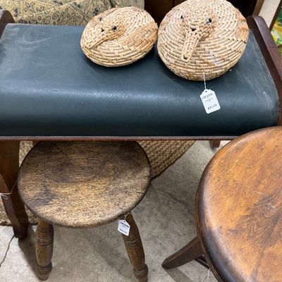 Sale Photo Thumbnail #6: Vintage dark green upholstered vanity bench with bentwood frame, paired with woven straw duck-shaped baskets and wooden round stools.