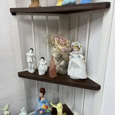 Porcelain figurines and decorative items, including Pierrot clown figures, a small doll in a white dress, a carved pink quartz figure,...