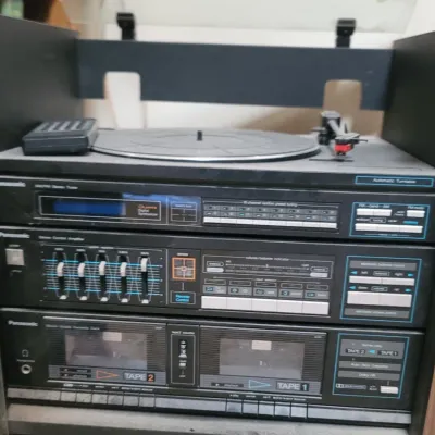 Sale Photo Thumbnail #13: Vintage 1980s Panasonic stereo rack system featuring a turntable, AM/FM synthesizer tuner, stereo control amplifier with graphic equalizer, and dual cassette deck, housed in a wooden cabinet.