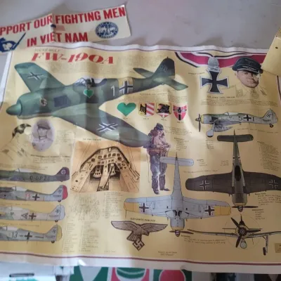 Sale Photo Thumbnail #40: Focke Wulf FW-190A military aircraft educational poster alongside a 'Support Our Fighting Men In Viet Nam' bumper sticker.