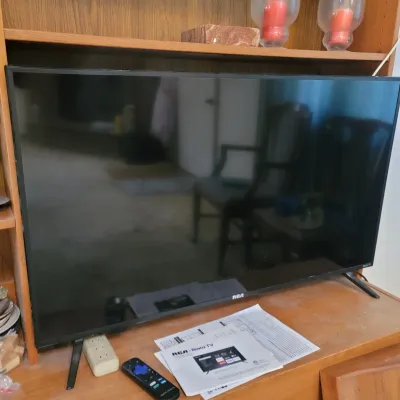 Sale Photo Thumbnail #9: RCA Roku flat-screen smart TV.