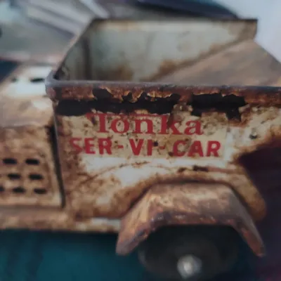 Sale Photo Thumbnail #35: Vintage Tonka Ser-Vi-Car pressed steel toy truck featuring heavy surface rust and original decals.