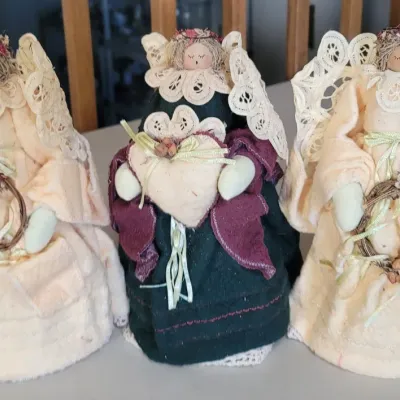 Sale Photo Thumbnail #30: Set of three vintage handcrafted fabric angel figurines featuring lace wings, yarn hair, and dried floral accents.
