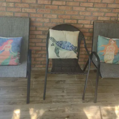 Three Patio Chairs With Decorative Pillows